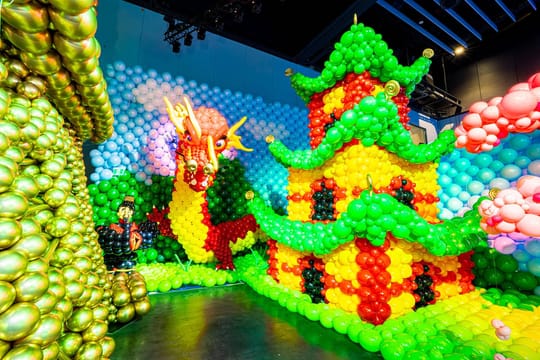 Colourful balloon installations depicting a dinosaur and other scenes inside the Balloon Story exhibition.