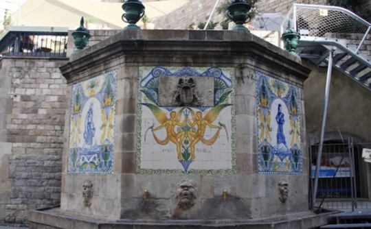 The Font de Sant Just in Barcelona's Gothic Quarter, showing its neoclassical design and two spouts.