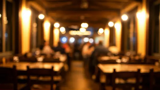 Interior of a traditional Catalan restaurant with a warm, inviting atmosphere, showing wooden tables and local decor.