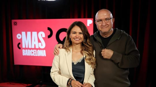 Erika Torregrossa, a woman with dark hair, smiles while speaking into a microphone during a podcast recording session.