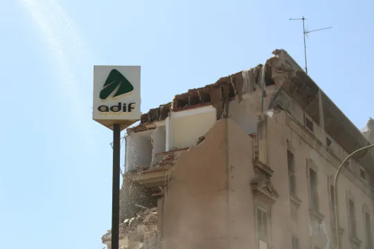Excavators demolishing the historic La Sagrera goods station in Barcelona, with debris and construction machinery visible.