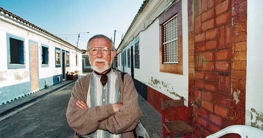 People in traditional costumes and homemade hoods participate in a religious procession in L'Hospitalet de Llobregat, Barcelo
