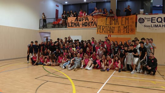 Lima Horta women's basketball team celebrating on court with fans