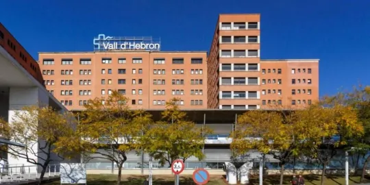 Rescue helicopter flying over the rocky peaks of Montserrat mountain range