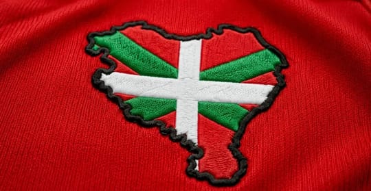 Athletic Club football kit with a small map of Euskal Herria on the back collar, showing the Basque flag colours.