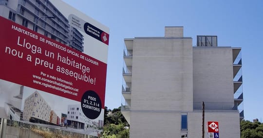 Modern affordable housing building in Barcelona with balconies and green spaces