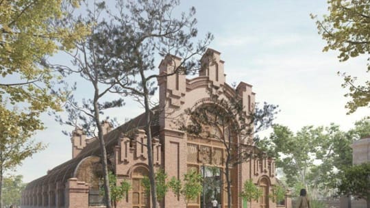 Historic Umbracle building in Barcelona's Ciutadella Park with lush tropical plants inside.