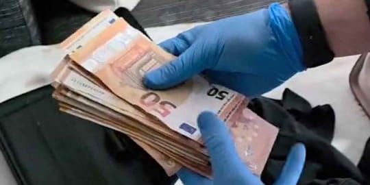 A close-up image of two €50 euro banknotes, one appearing genuine and the other showing subtle signs of being counterfeit.