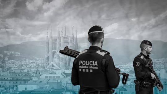 A Guardia Urbana patrol car parked on a street in Barcelona, with a police officer visible nearby.