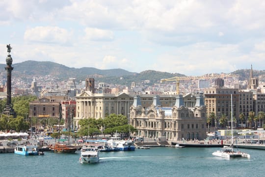 An aerial view of Barcelona's Ciutat Vella district, showing the Raval neighbourhood, La Rambla, and the coastline leading to