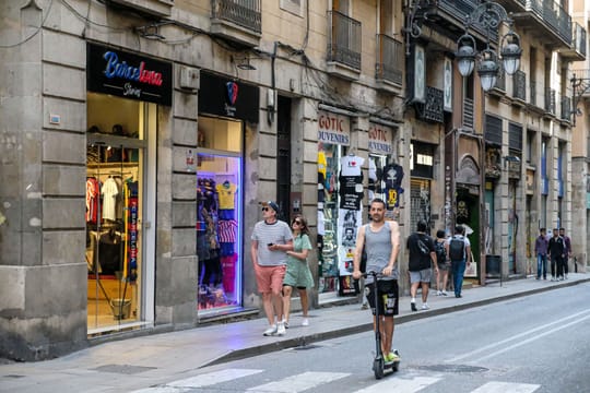 Barcelona's Ciutat Vella district with historic buildings and bustling streets, representing urban development.