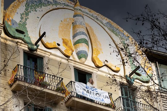 The facade of Bloc Papallona in Barcelona, featuring a large butterfly mosaic and Modernista architectural details.