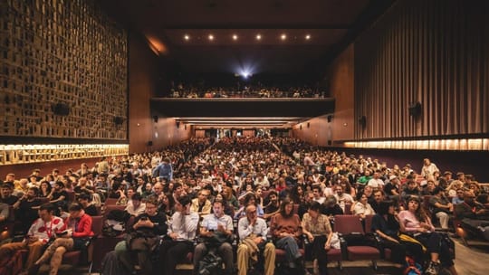 People watching a documentary film screening at the DocsBarcelona festival in a cinema