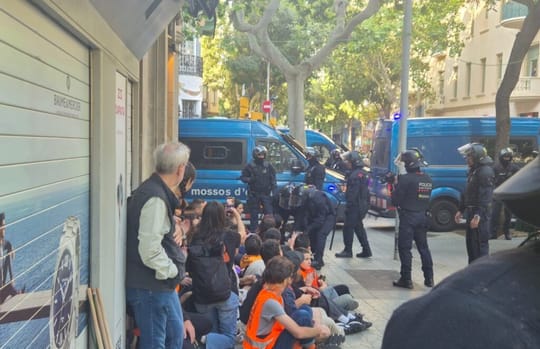 Mossos d'Esquadra BRIMO officers standing outside an apartment building in Barcelona's Eixample district during an eviction.