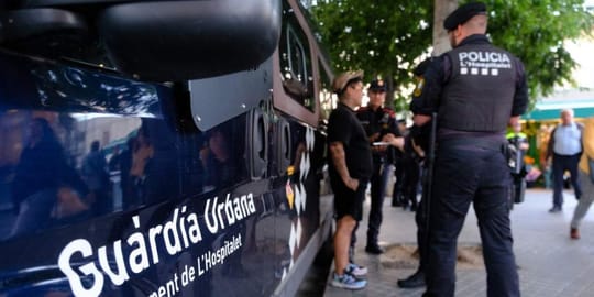 Police officers on patrol in L'Hospitalet de Llobregat, with an electric scooter in the foreground, during an anti-crime oper
