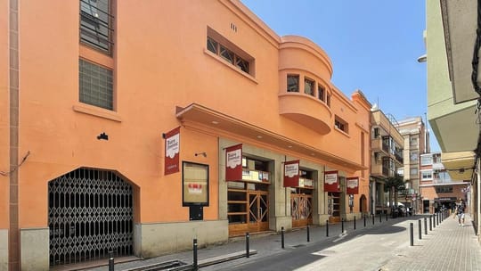Exterior view of Teatre Joventut in L'Hospitalet de Llobregat, a historic building with a large entrance.