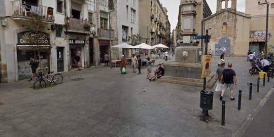 Police tape or a street scene in Barcelona's Raval district, possibly near Plaça del Pedró, indicating an investigation.