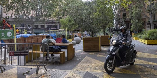 A busy street in Sant Antoni, Barcelona, with shops and people, illustrating the urban environment affected by security conce