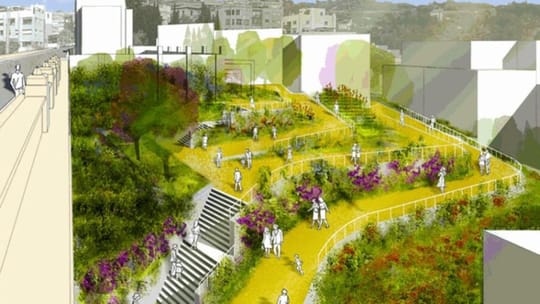 An aerial view of a modern urban park with green spaces, walking paths, and trees, surrounded by residential buildings in a c