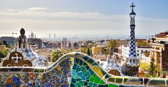 A street scene in Barcelona's Poble-sec neighbourhood, showing residential buildings and a public space.
