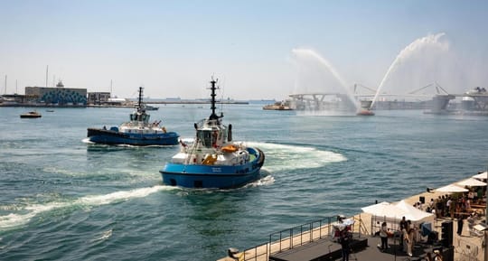 Service vessels from the Port of Barcelona perform a choreographed "boat dance" with water cannons near the World Trade Cente