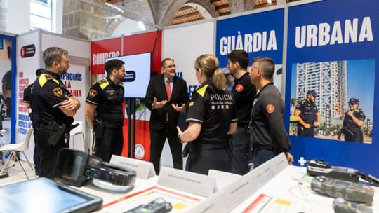 A Barcelona Urban Guard officer and a Barcelona firefighter stand together in uniform, representing the city's emergency serv