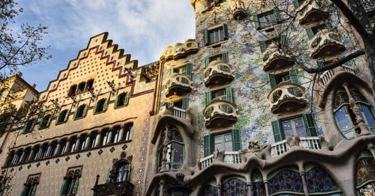The historic Teresian College building in Barcelona, designed by Antoni Gaudí, with its distinctive brick facade and paraboli