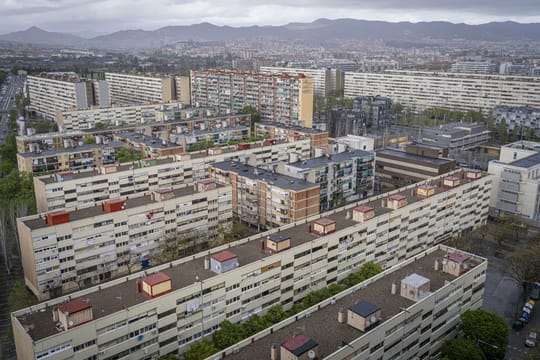 Police car parked on a street in a residential area, possibly in La Mina, Sant Adrià de Besòs, with apartment buildings in th
