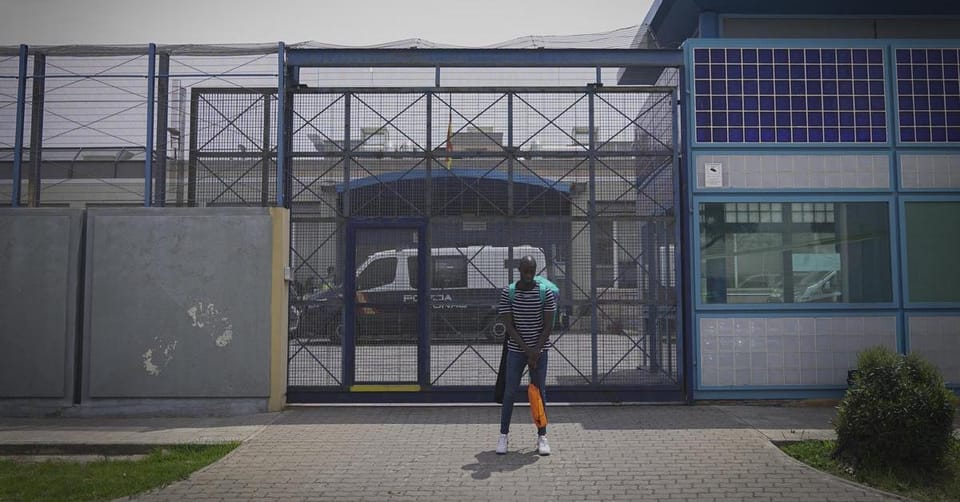 Exterior view of the Centre d'Internament d'Estrangers (CIE) in Barcelona's Zona Franca, with a low tower painted blue and wh