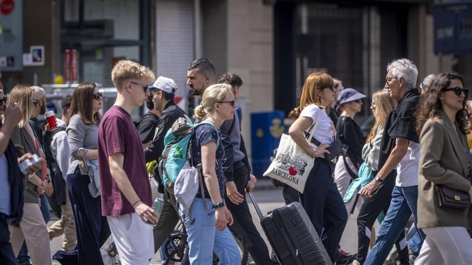Tourists sitting on stairs and in a hallway of a hotel, looking frustrated.