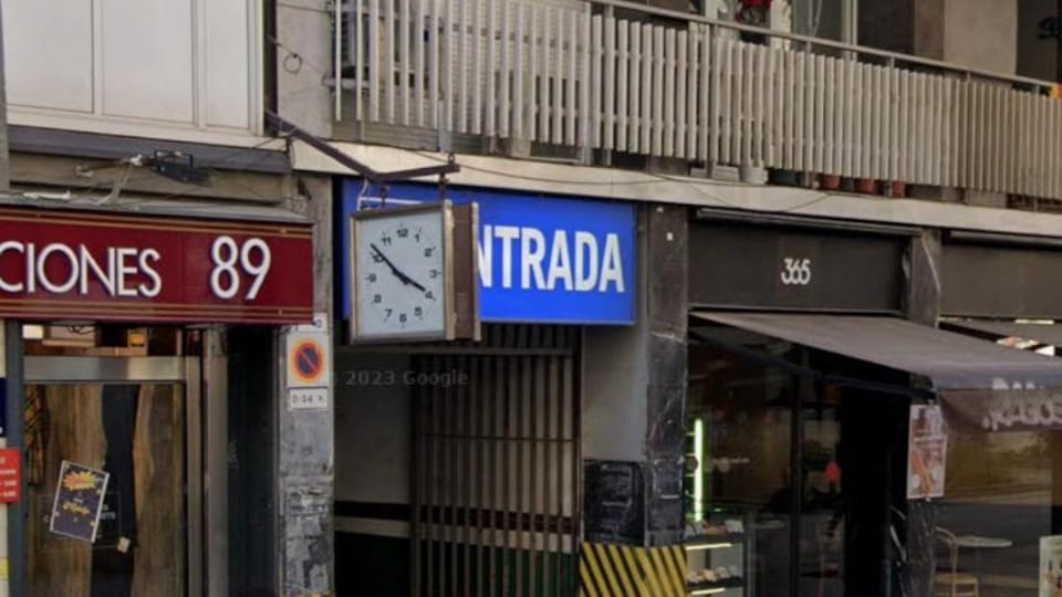 Historic clock with ornate hands and Roman numerals on the facade of a building in Barcelona's Sant Antoni neighbourhood
