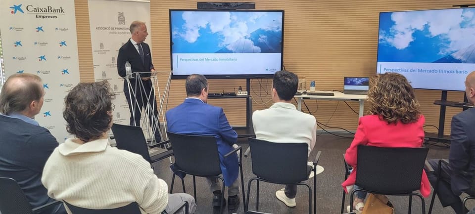 New residential buildings under construction in Viladecans, Barcelona, with cranes visible against a clear sky.