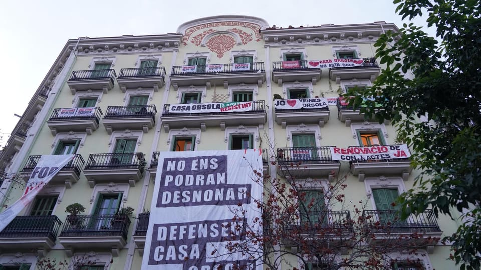 Barcelona's Eixample district with residential buildings and a street.