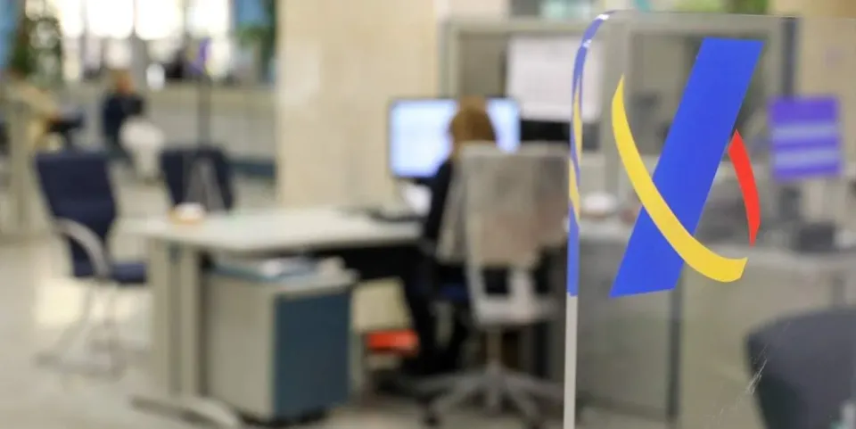 A person's hands typing on a laptop keyboard with a padlock icon on the screen, symbolising online security and phishing scam