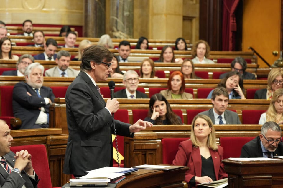 View of Barcelona-El Prat Airport terminal building with planes on the tarmac and the control tower in the background under a