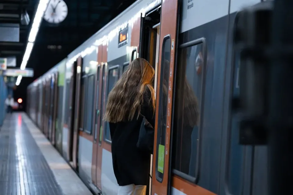 An FGC train on the L6 line at a station platform in Barcelona.