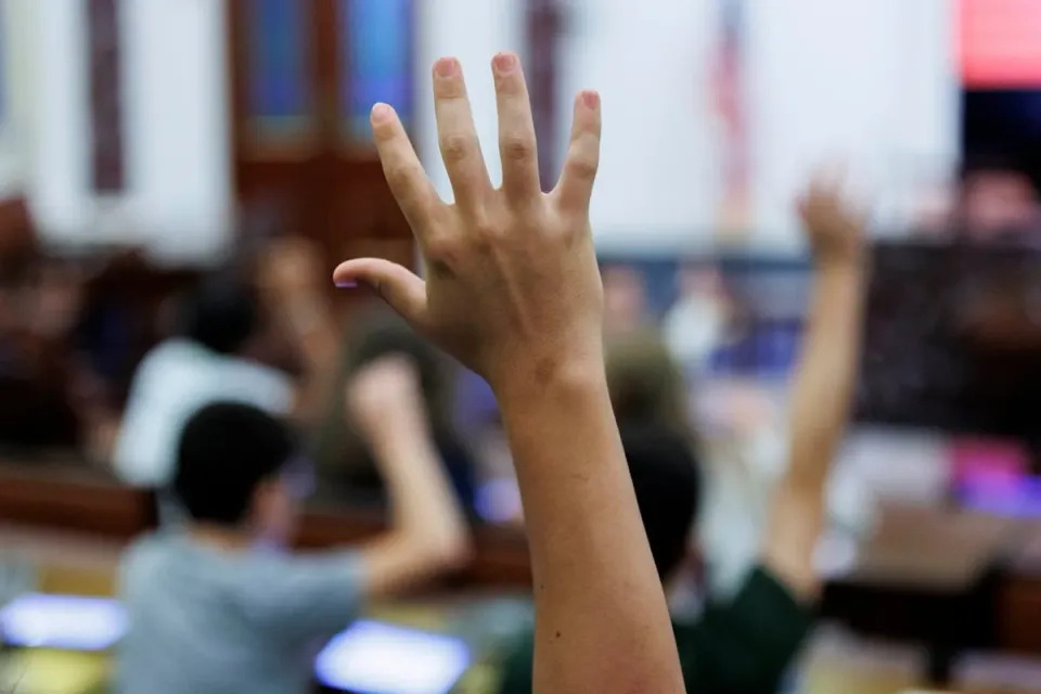 A child's backpack and school books on a desk, symbolising a student out of school.