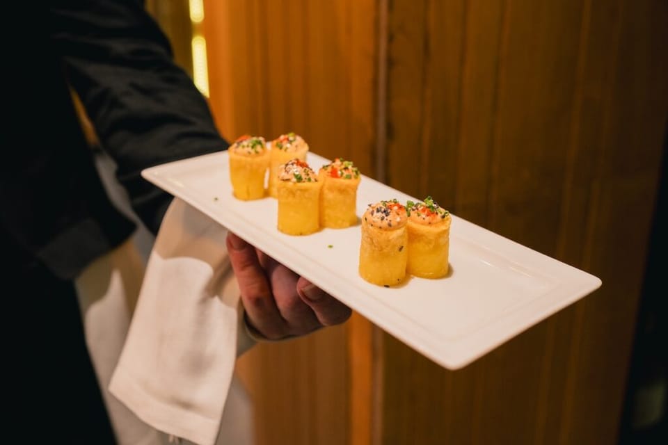 Interior of Taverna del Clínic restaurant with tables and a modern, welcoming atmosphere.