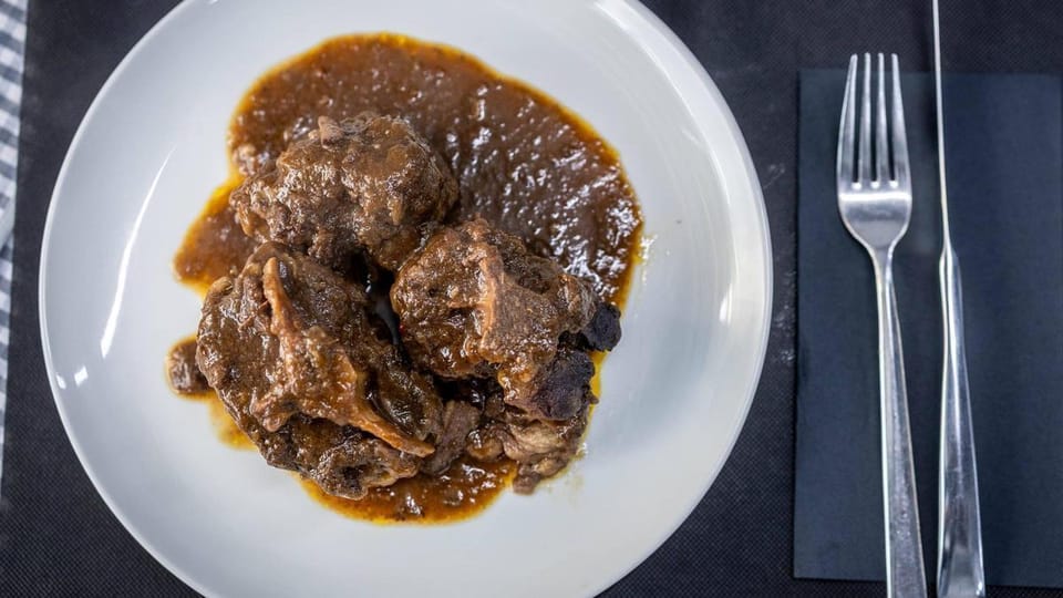 A bustling restaurant interior with diners enjoying meals, possibly in Barcelona's Zona Franca district.