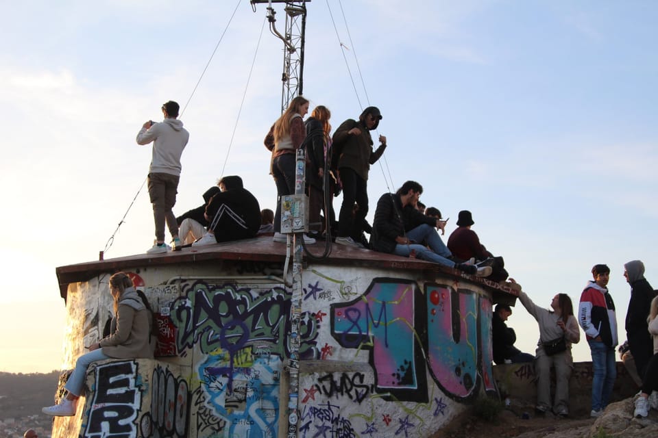 Panoramic view of Barcelona from the Carmel Bunkers at Turó de la Rovira, showing the city skyline and the Mediterranean Sea.