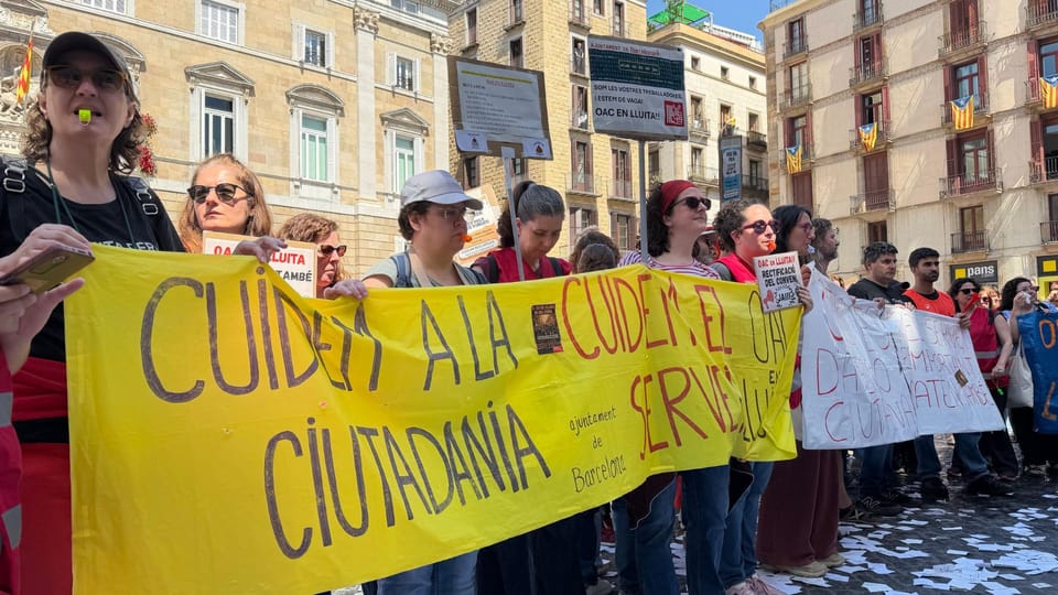 Barcelona City Council building with a protest banner outside.