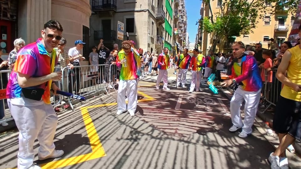 Humorous choral groups, known as Cors Muts, parade through the streets of Barceloneta, Barcelona, with wooden instruments and