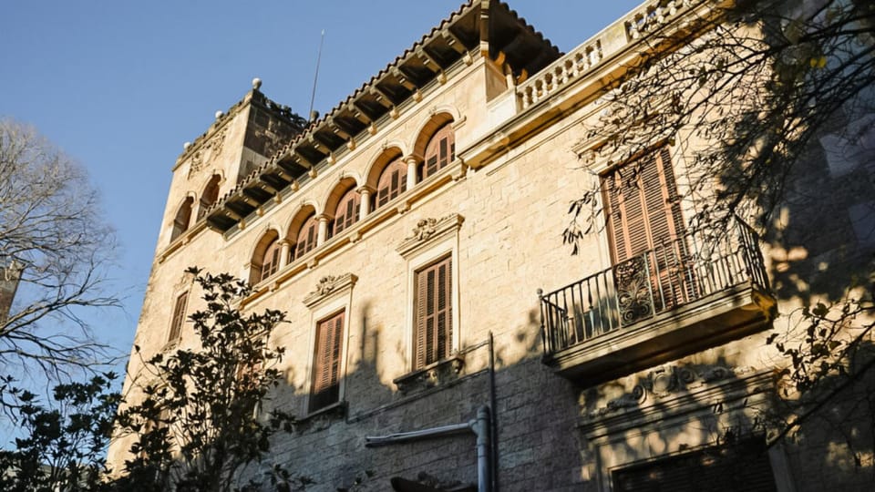 Exterior view of the historic Julio Muñoz Ramonet estate in Barcelona, showing its elegant facade and surrounding gardens.