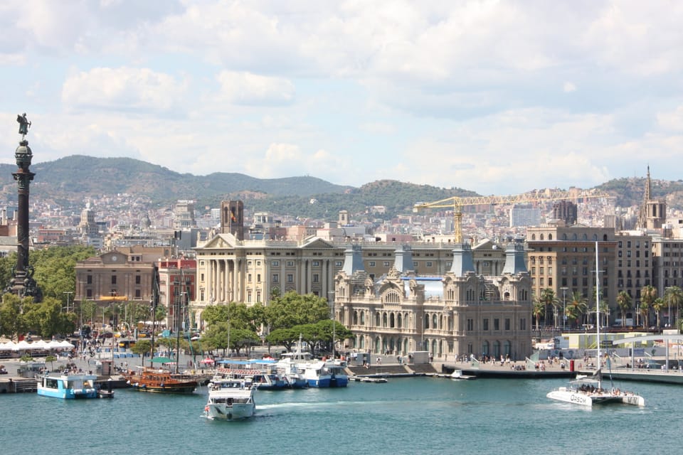 An aerial view of Barcelona's Ciutat Vella district, showing the Raval neighbourhood, La Rambla, and the coastline leading to