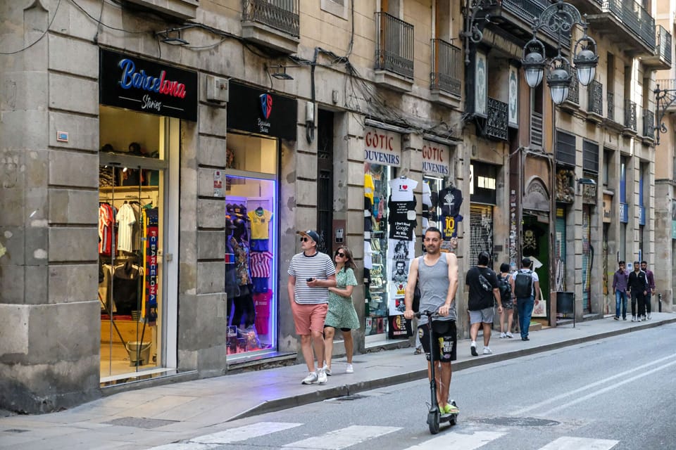Barcelona's Ciutat Vella district with historic buildings and bustling streets, representing urban development.