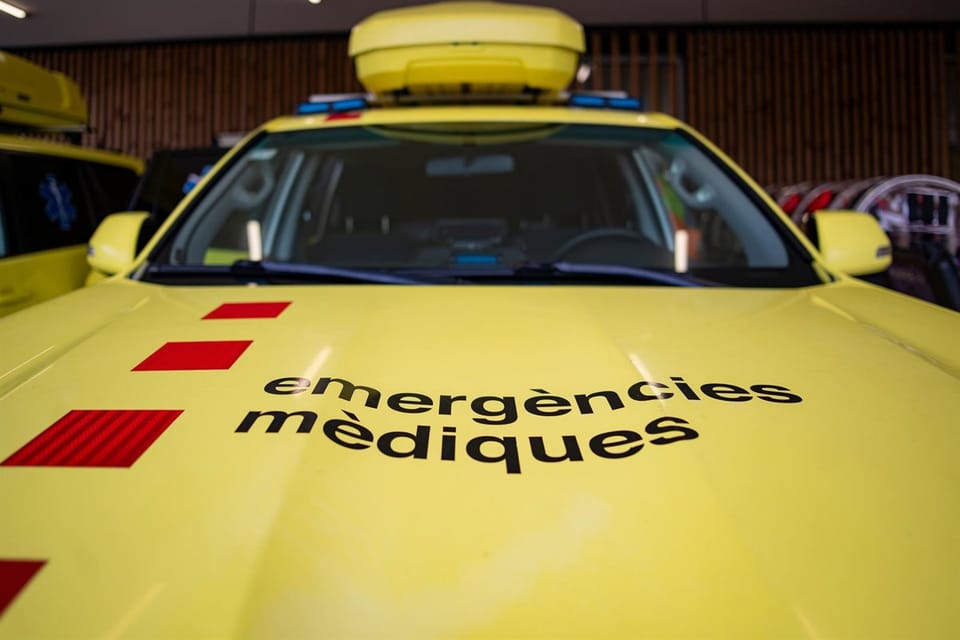 Emergency services attend a road accident scene with a damaged motorcycle and cars.