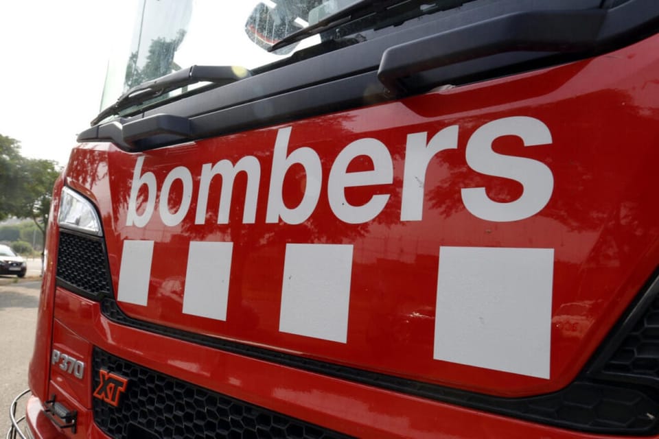 Emergency services vehicles, including fire engines and ambulances, at the scene of a house fire in Catalonia.
