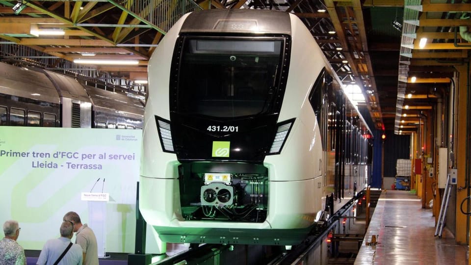 A modern FGC train on tracks, with a station platform visible, representing improved commuter rail services.