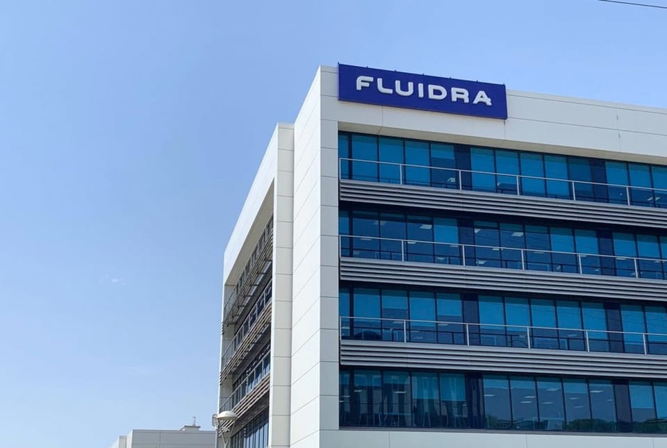 Fluidra logo displayed on a building facade, representing the company's global presence in the pool and wellness sector.
