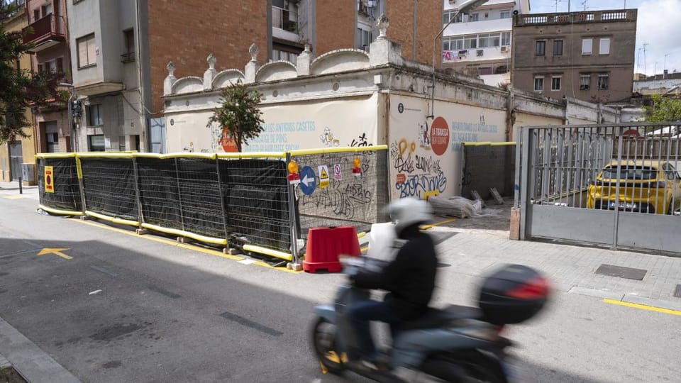 Renovated historic small houses with colourful facades and new windows in L'Hospitalet de Llobregat.